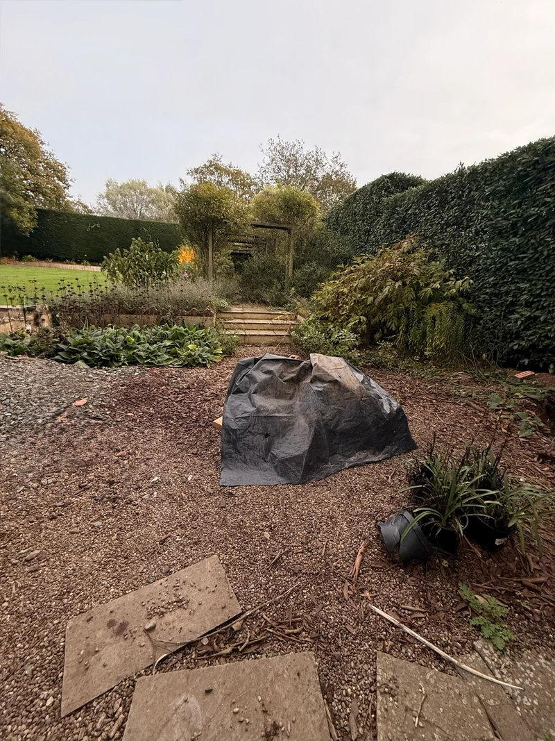 Old slabs lifted and stacked, with materials waiting to go in.