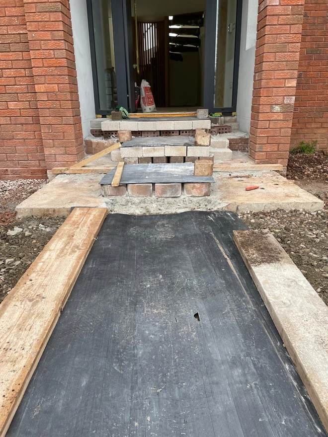The steps under construction, showing the blockwork and membrane beneath.